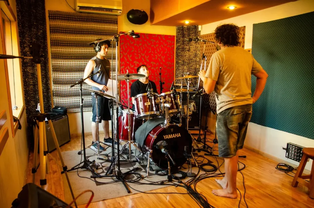 drummer recording drums with a band on a Yamaha kit