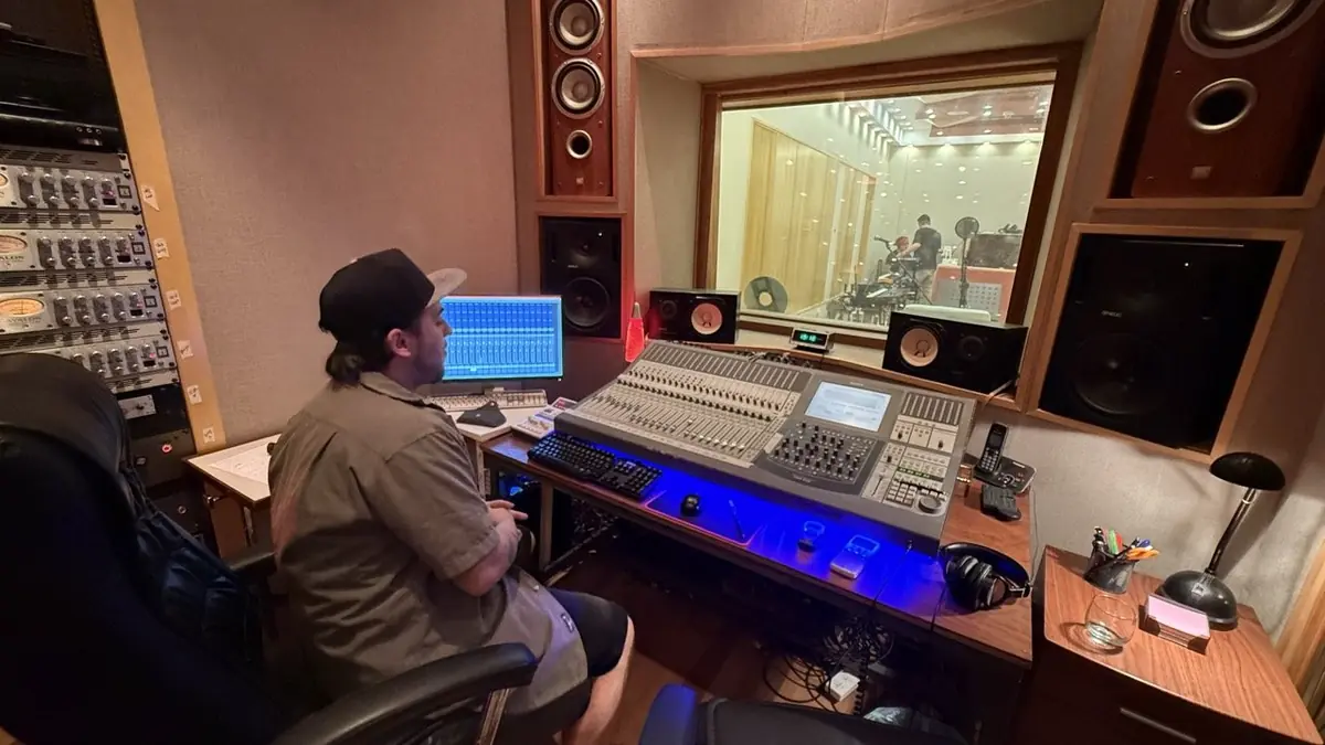 Session drummer Ezequiel "Drumkid" at the mixing console in his recording studio