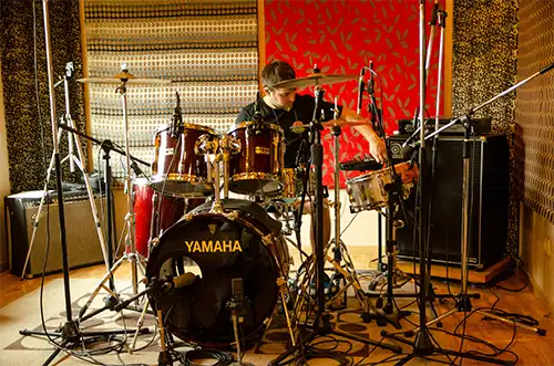 Professional multi-track drum recording session with kick, snare, toms and overheads
