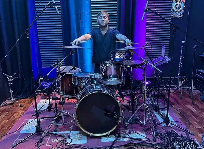  ready to trackProfessional session drummer behind a fully mic'd drum kit in the studio