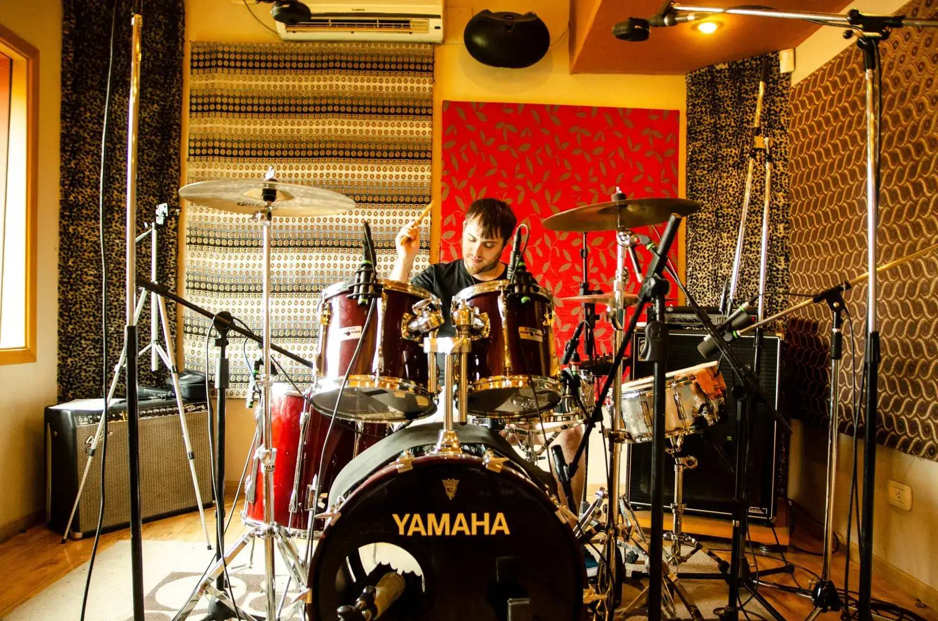 Professional online session drummer recording reggae drum tracks in studio