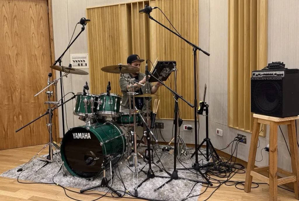 Remote session drummer recording reggae drum tracks in studio